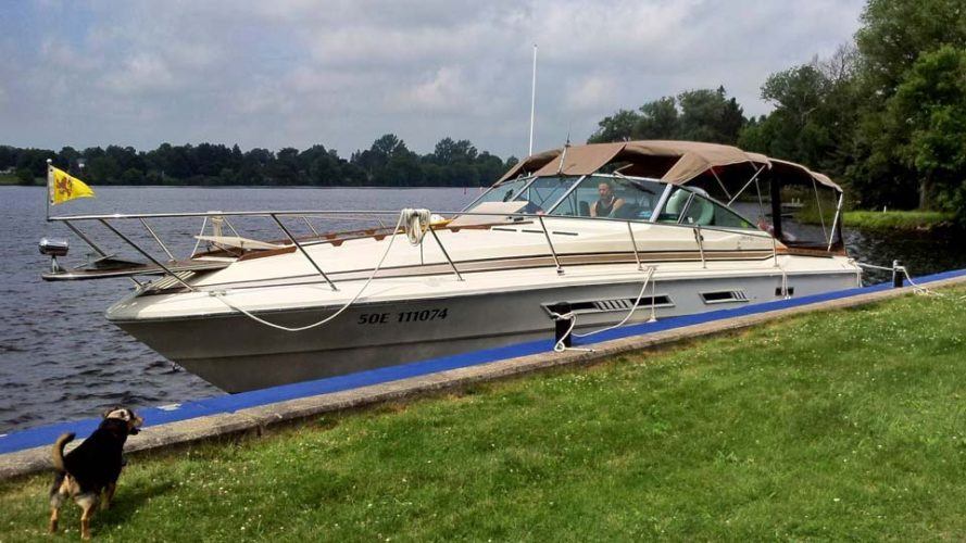 large boat docked next to land