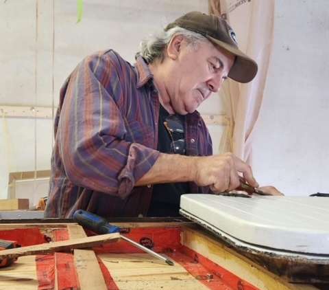 a man working on a piece of furniture