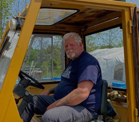 a man sitting in the driver's seat of a tractor