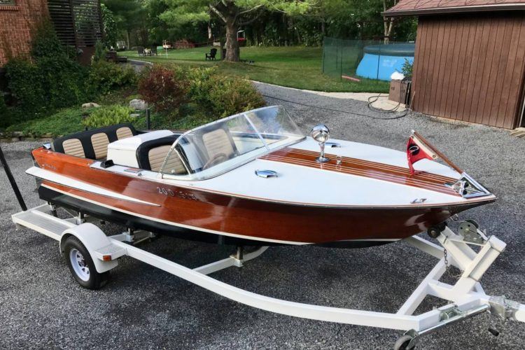 a small boat with a trailer attached to it