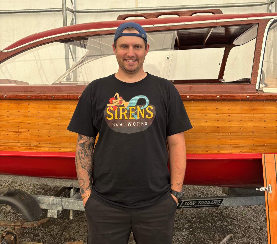 a man standing in front of a boat